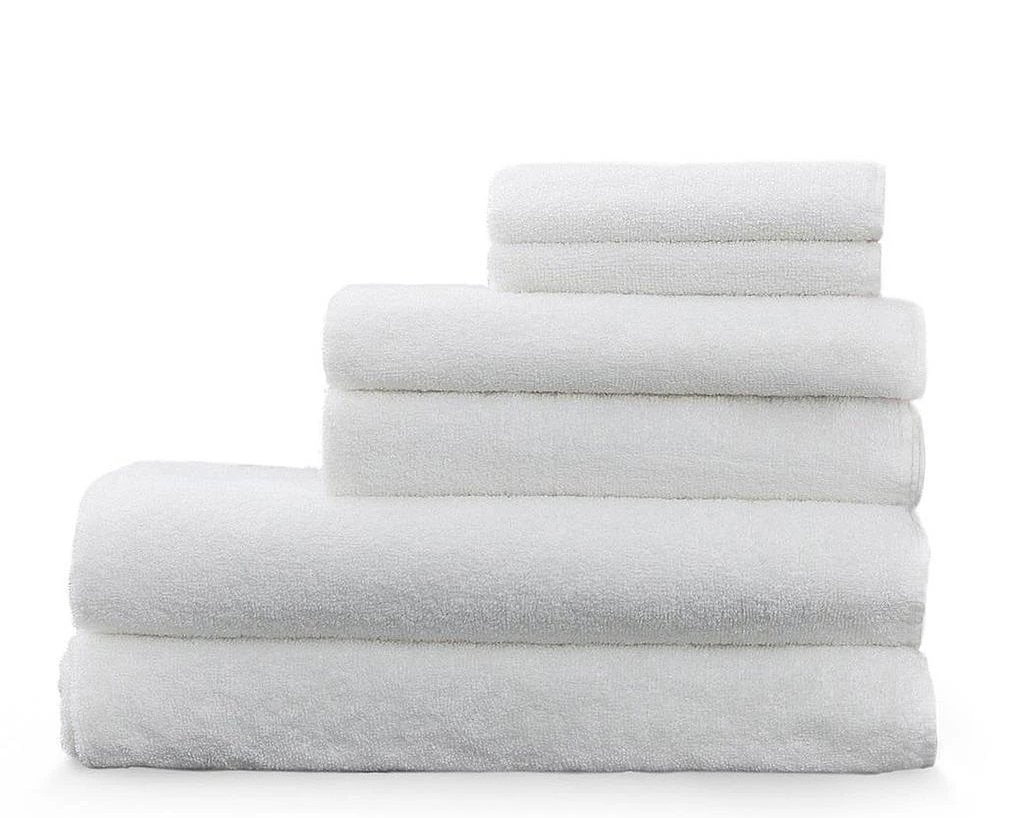 Snow - white Enso washcloths and hand towels stacked on top of our bamboo luxury towels